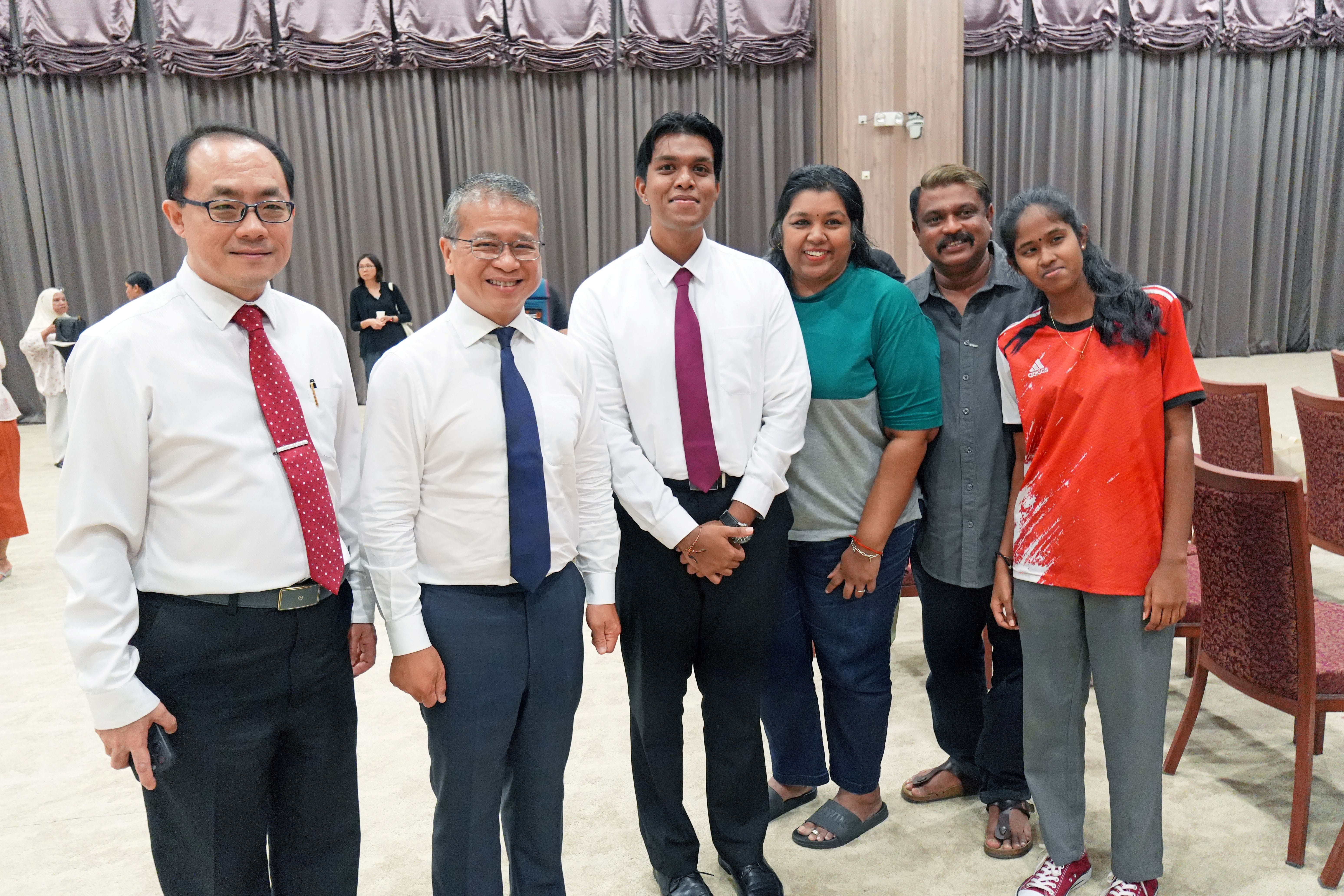 Scholarship recipient posing with family and GOH